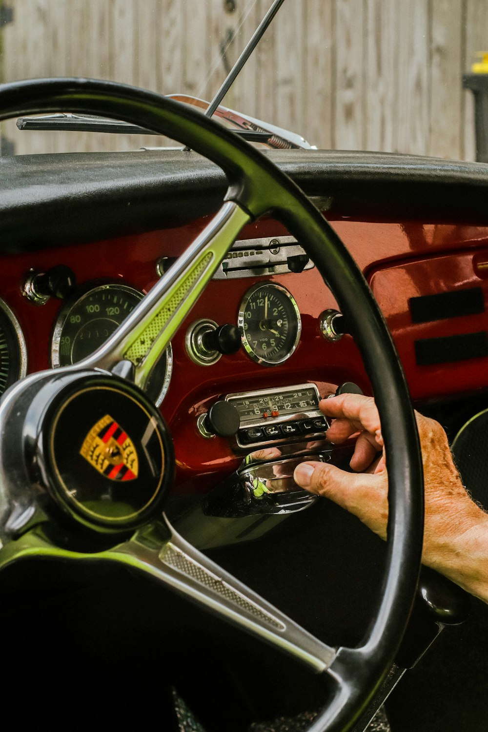 a man sitting in a car with a steering wheel
