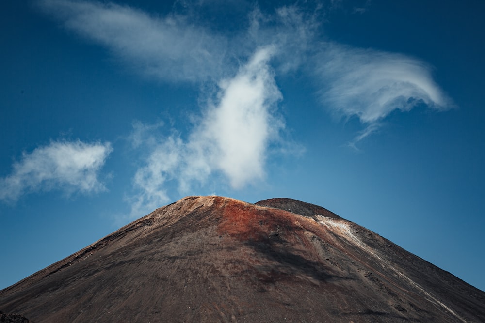 a very tall mountain with a cloud in the sky