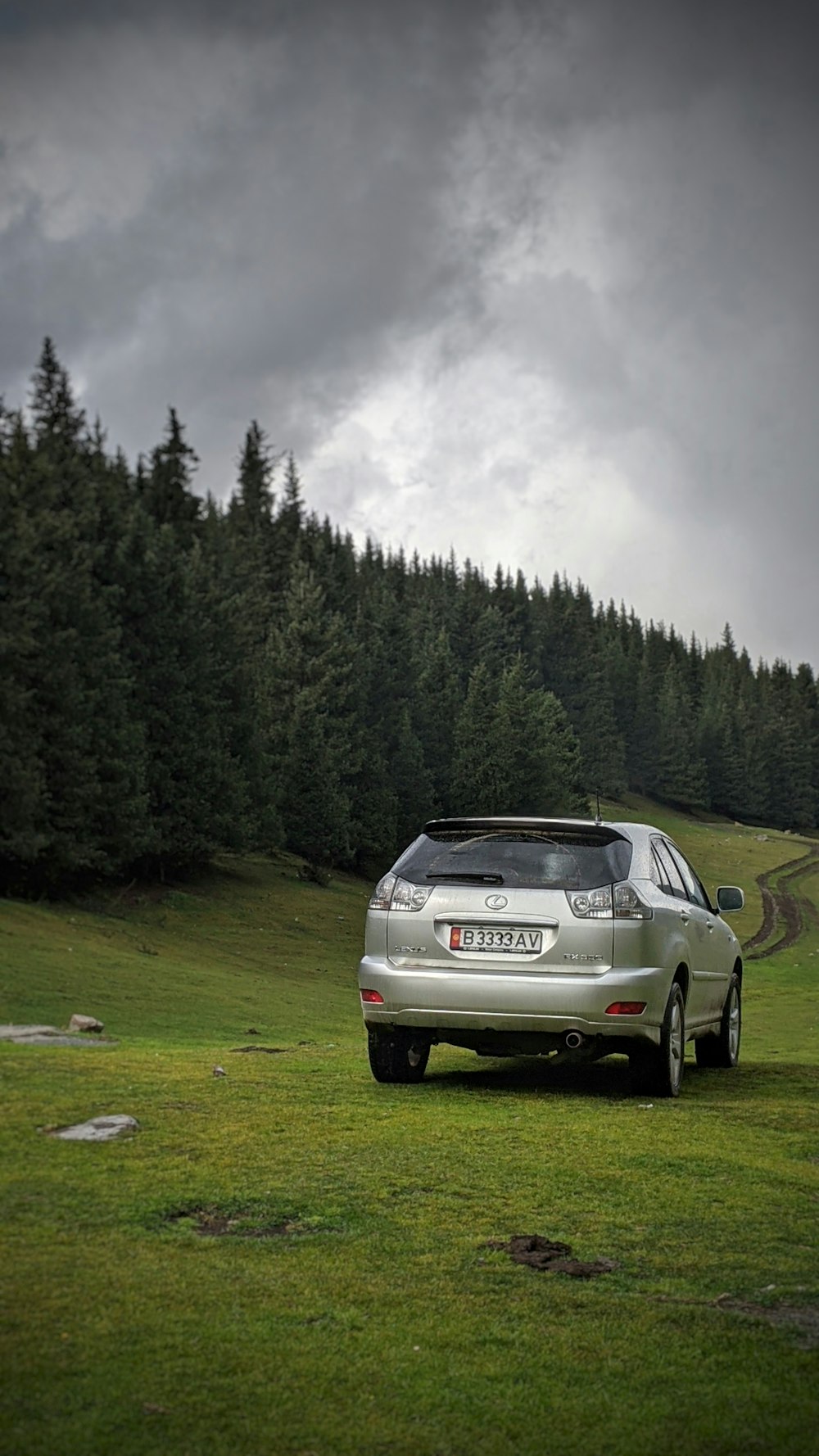 a silver car parked on the side of a road