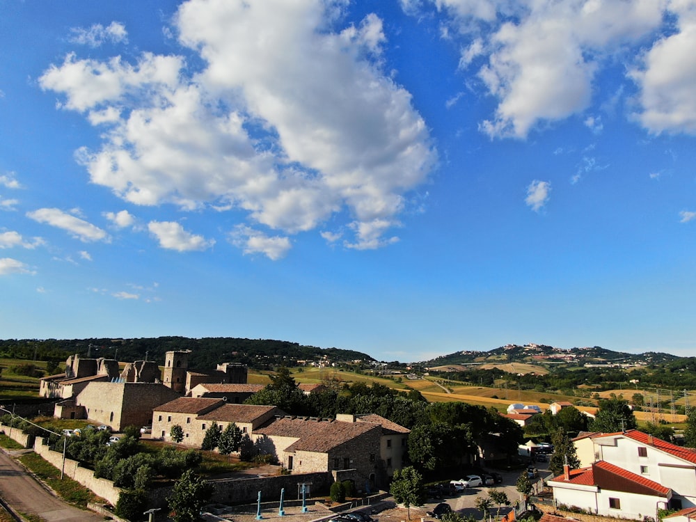 an aerial view of a town with a blue sky