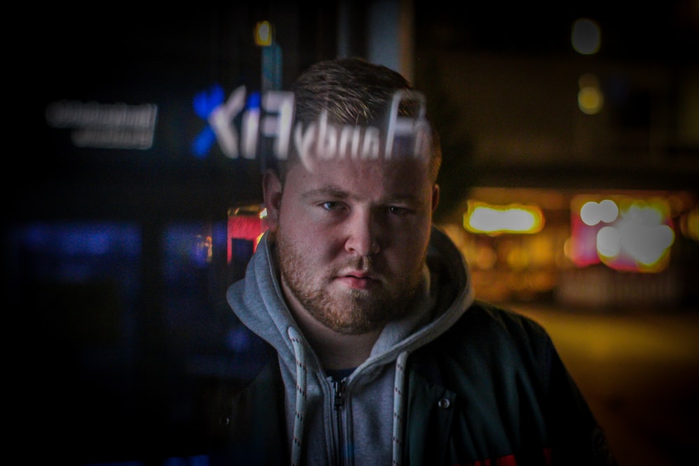 a man standing in front of a building at night