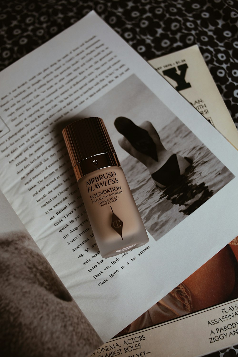 a picture of a bottle of foundation on top of a magazine