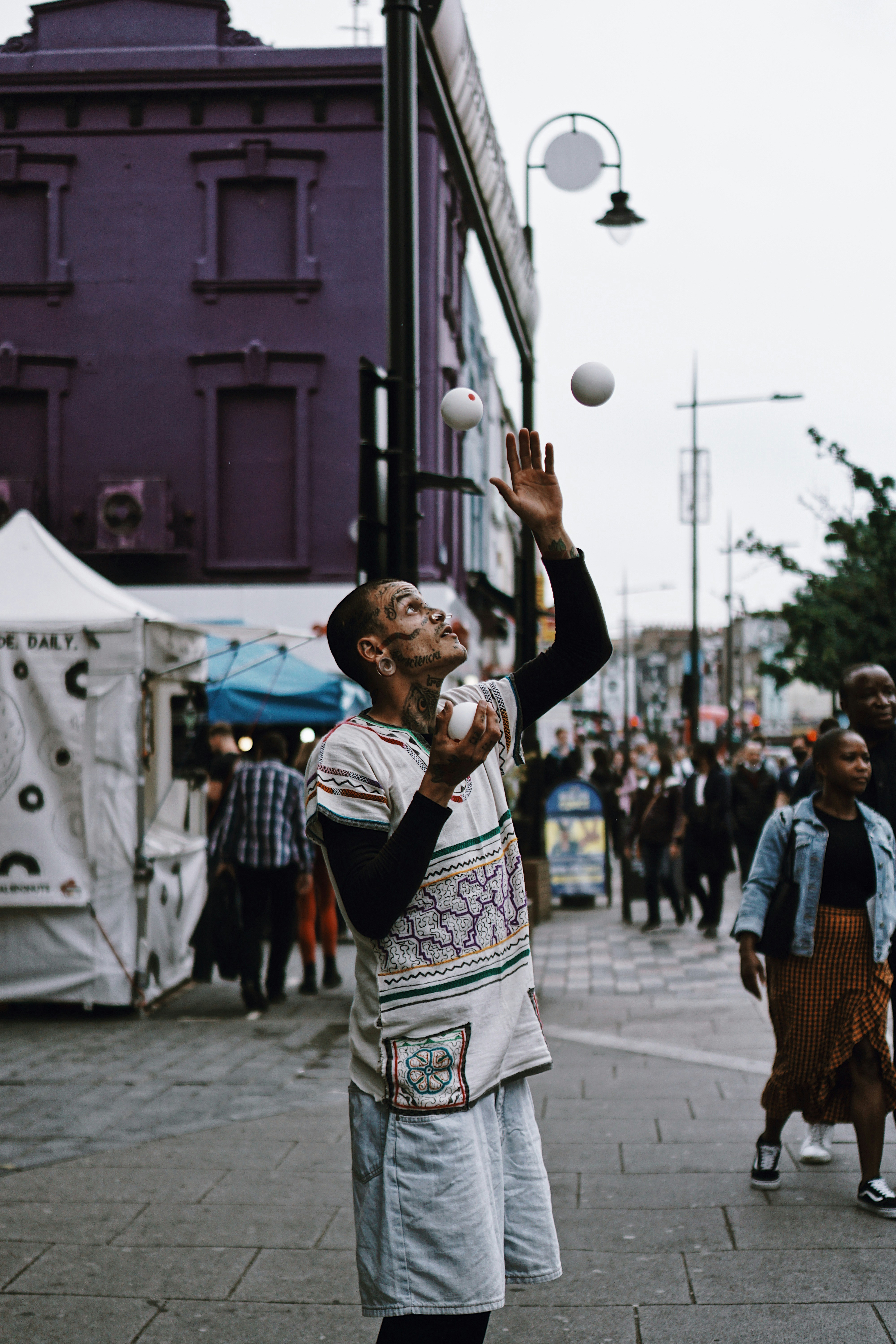 a man juggling a ball on a city street