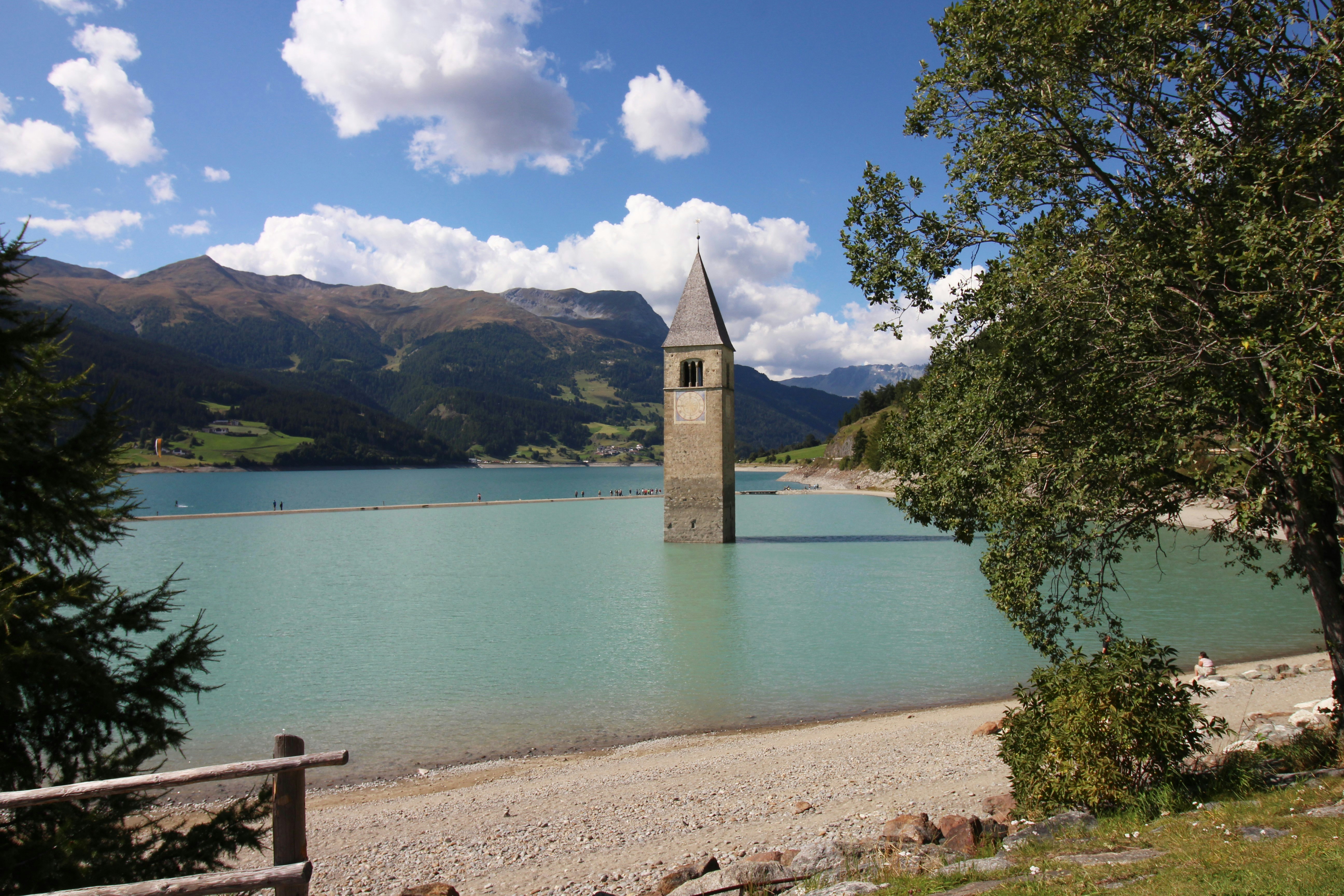 a clock tower sitting in the middle of a lake