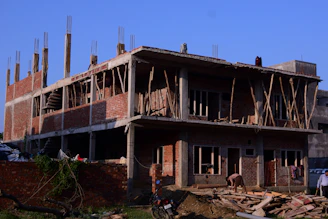 a building under construction with a horse in the foreground