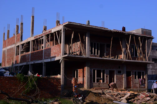 a building under construction with a horse in the foreground