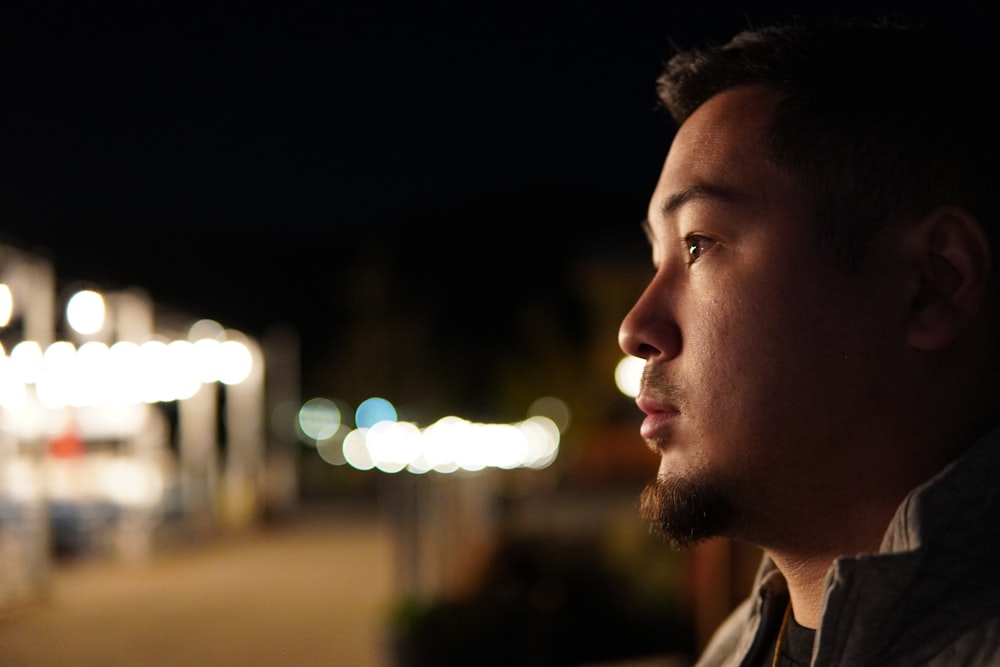 a man looking off into the distance at night