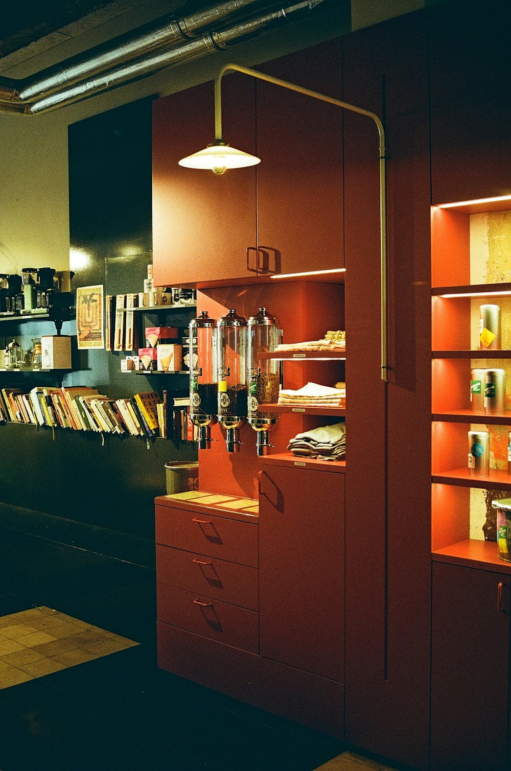 a room with a lot of books and a lamp