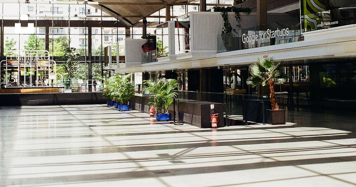 A large open building with a skylight and plants photo – Free Paris ...