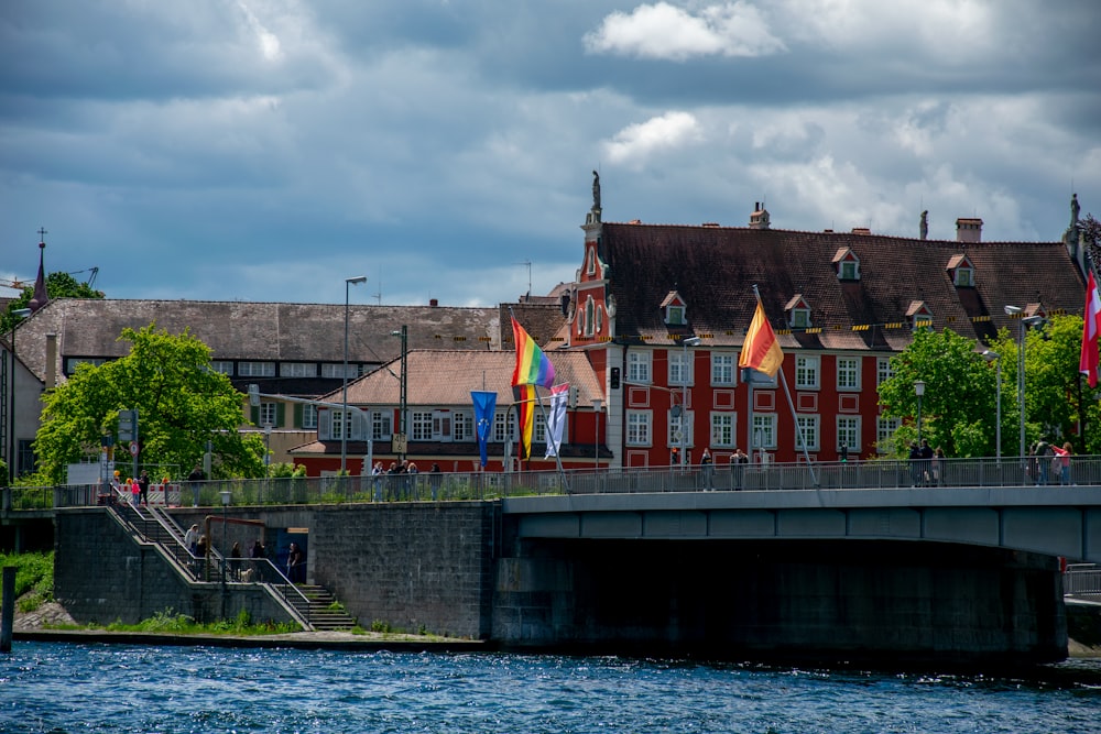 a bridge over a body of water with buildings in the background