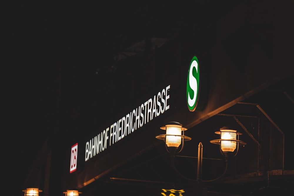 a street sign is lit up at night