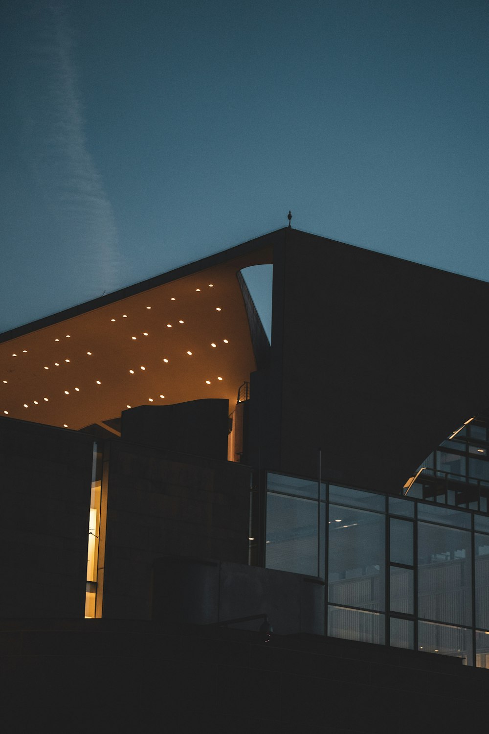 a building with a lit up roof at night