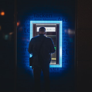 a man standing in front of an atm machine