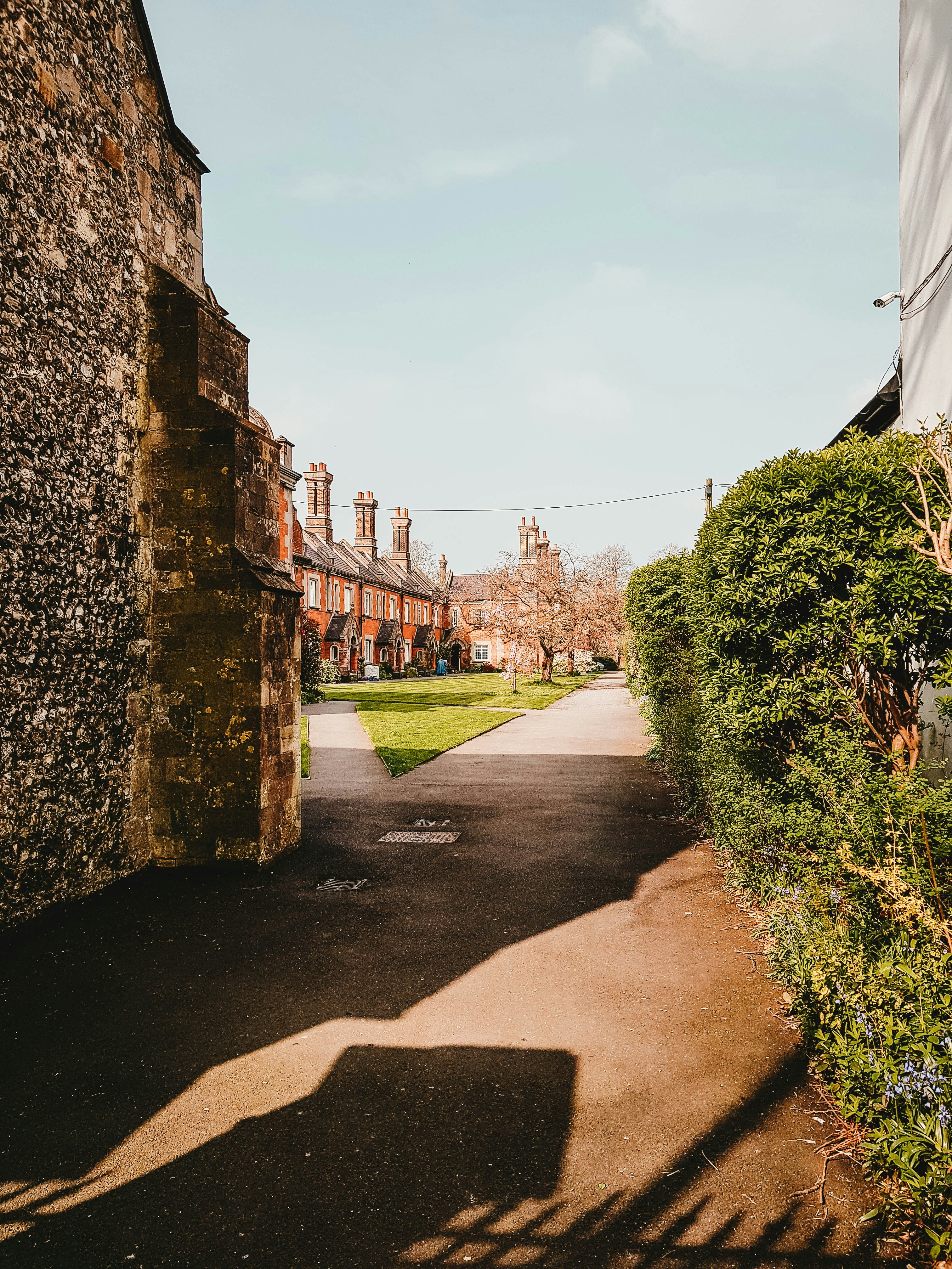 a narrow road with a building in the background