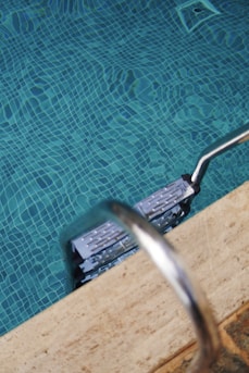 a pool of water with a metal handle on it