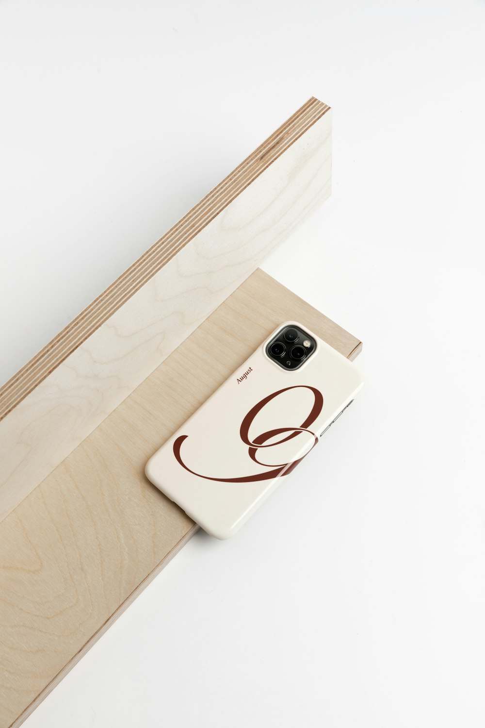 a cell phone sitting on top of a piece of wood