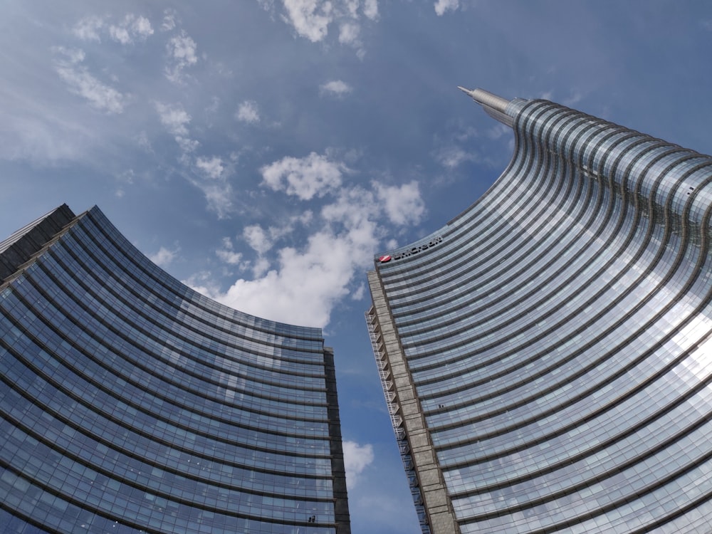 two tall buildings with a sky background