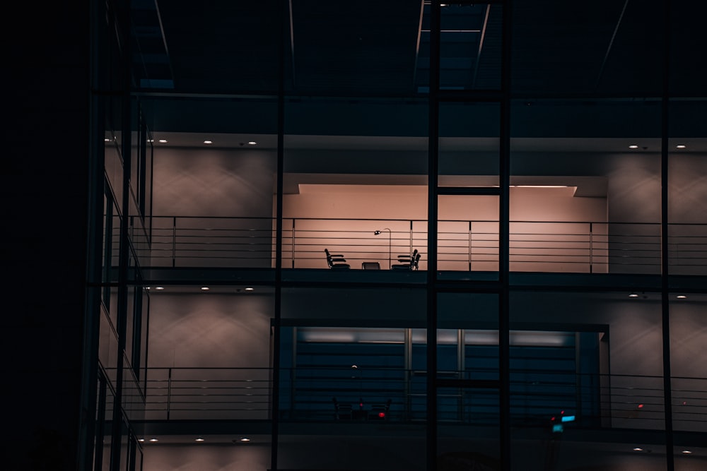 a person sitting at a table on a balcony at night