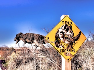 A roaring T-Rex standing in a prehistoric landscape under a cloudy sky.