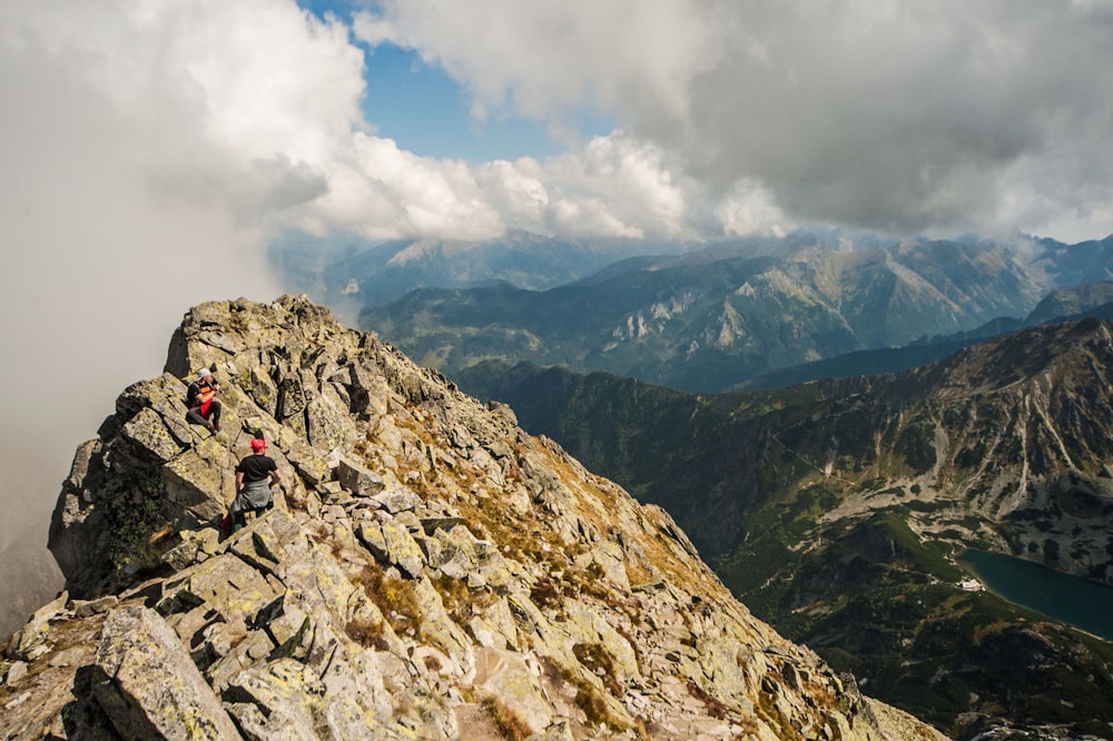 a group of people climbing up the side of a mountain