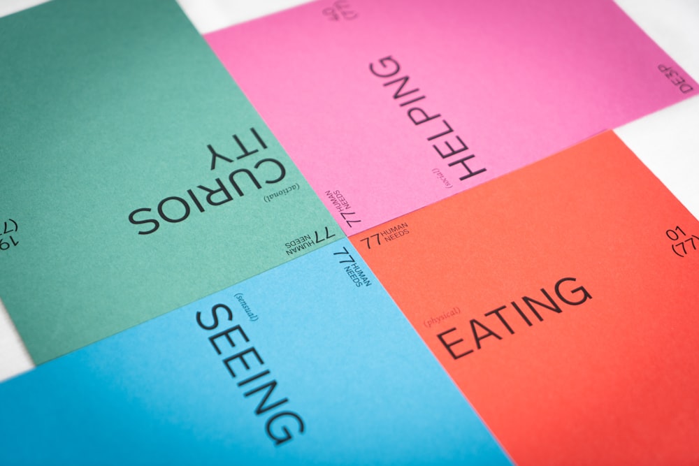 a close up of four different colored sheets of paper