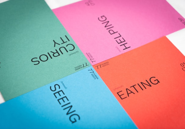 a close up of four different colored sheets of paper