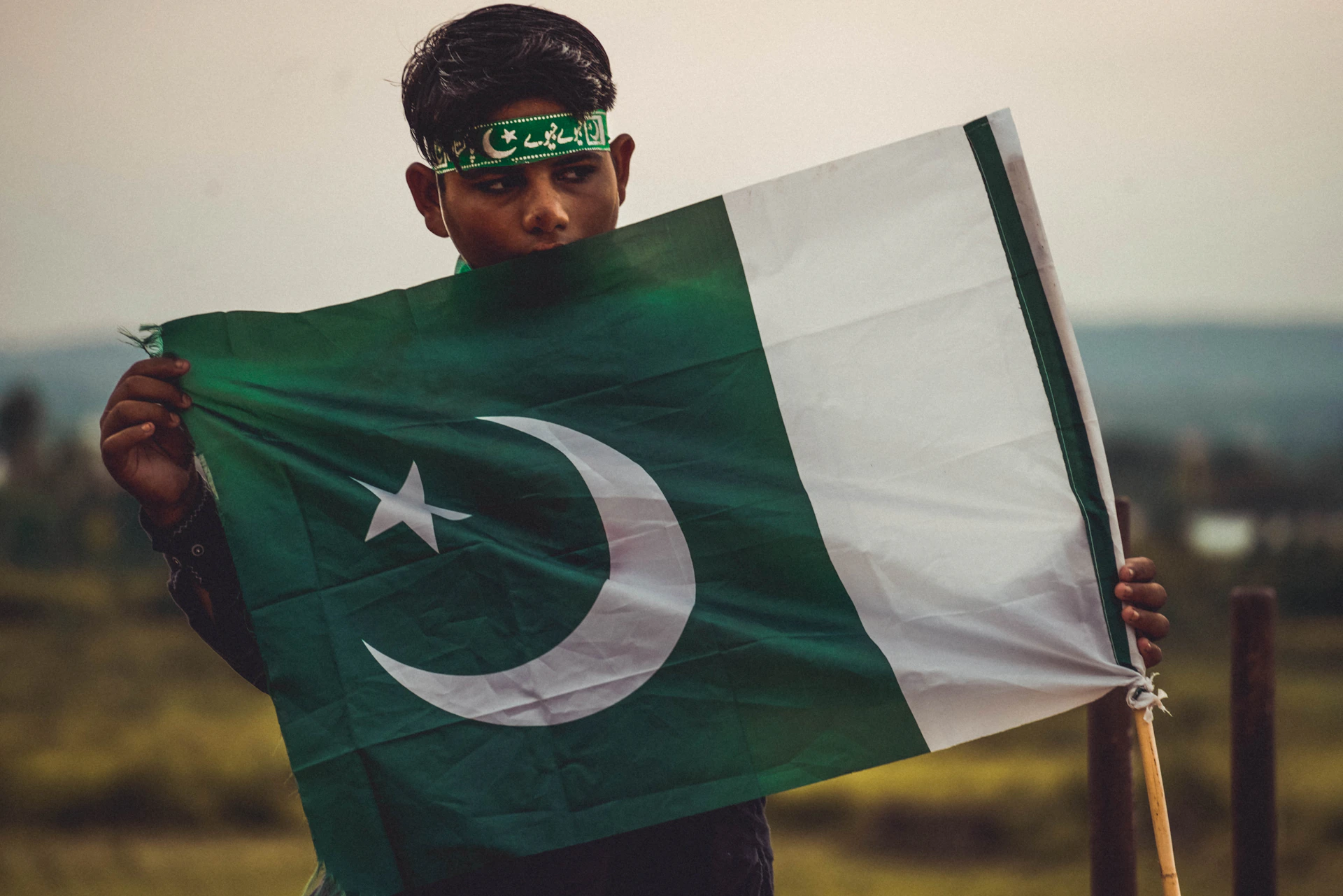 a young man holding a flag in his hands