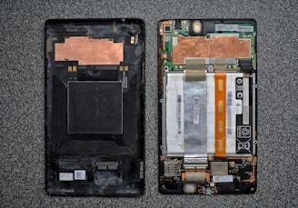 a cell phone with a broken battery attached to it