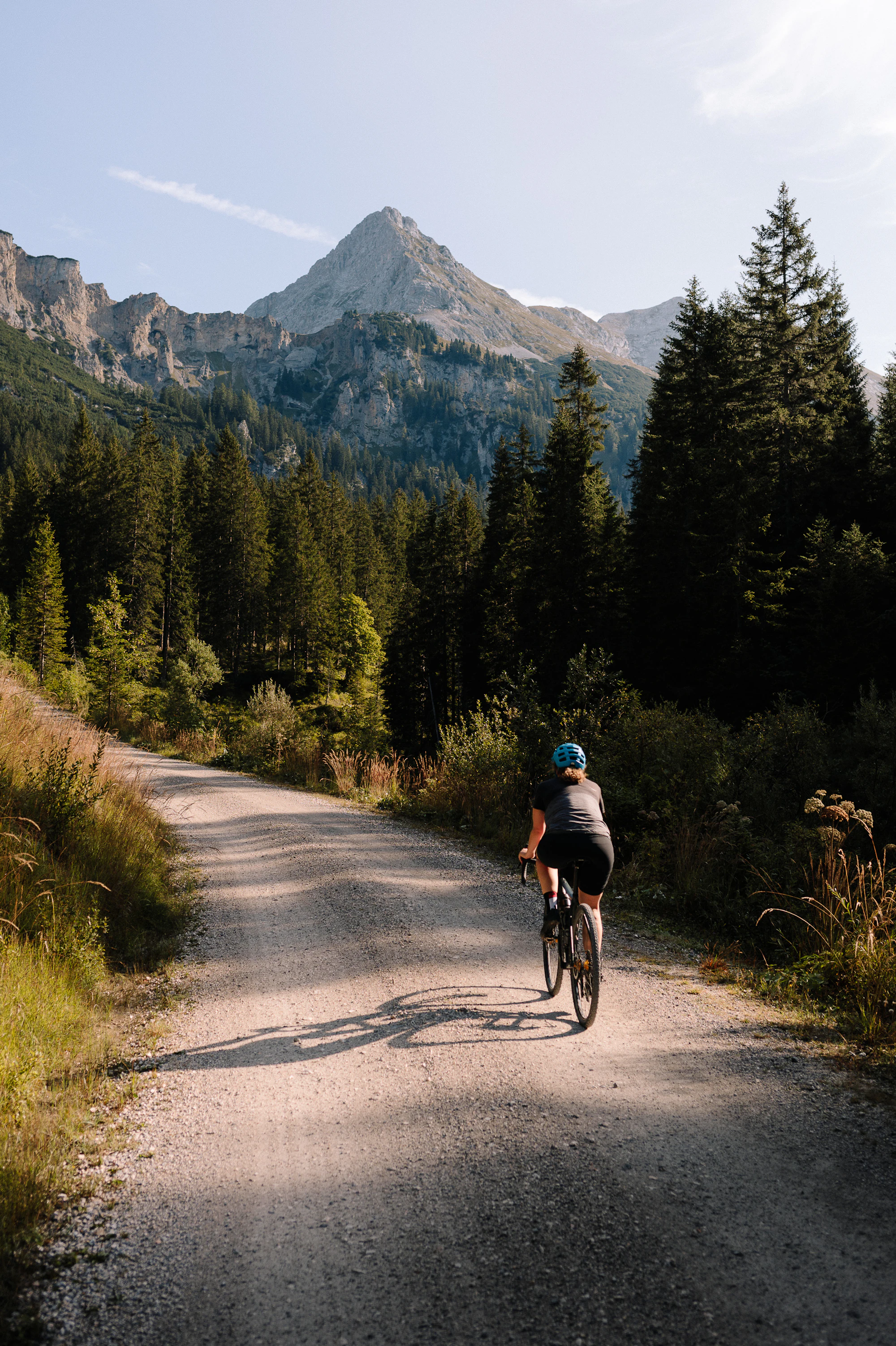 A rider on a gravel road at dusk