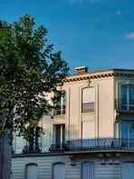 a tall white building with balconies and balconies