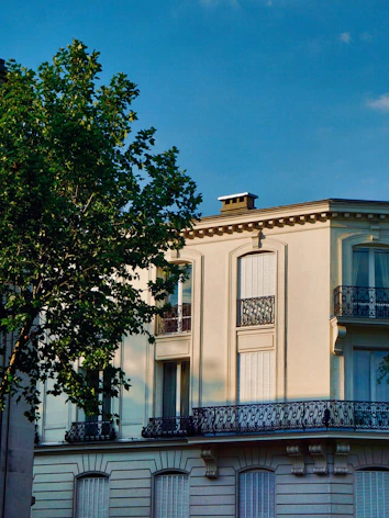 a tall white building with balconies and balconies