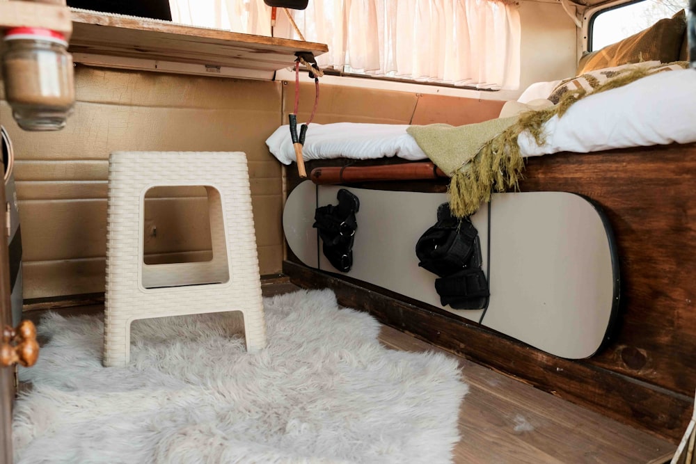 a bedroom with a bed and a snowboard on the floor