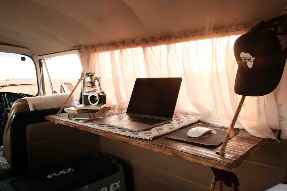 a laptop computer sitting on top of a wooden desk