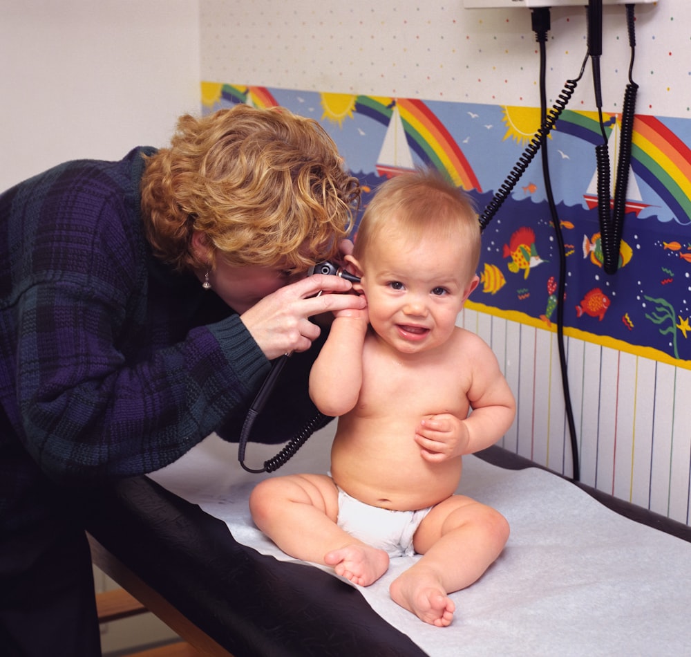 a woman is talking on a phone to a baby