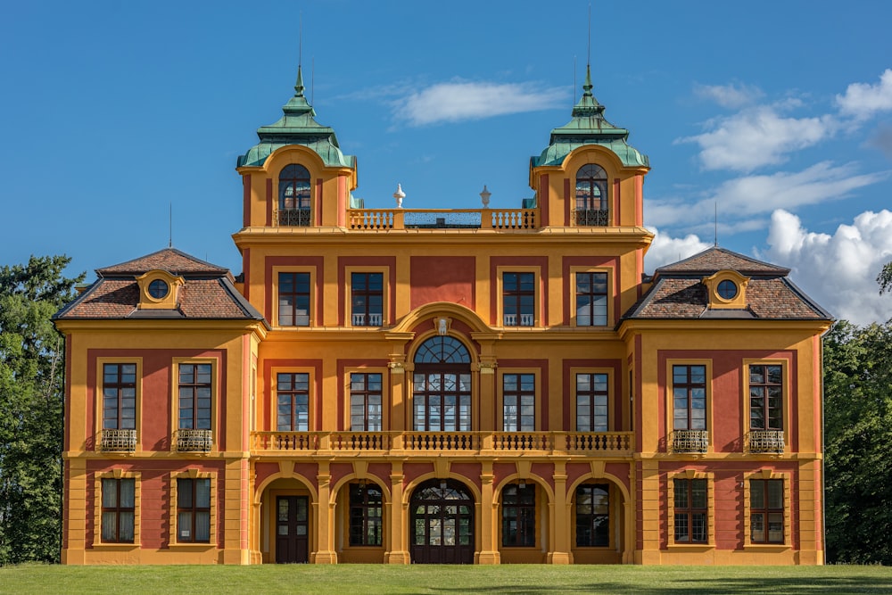 a large orange and yellow building with two towers