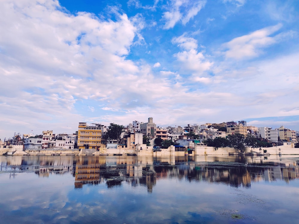 a body of water with a city in the background