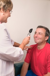 a man getting his teeth brushed by a doctor
