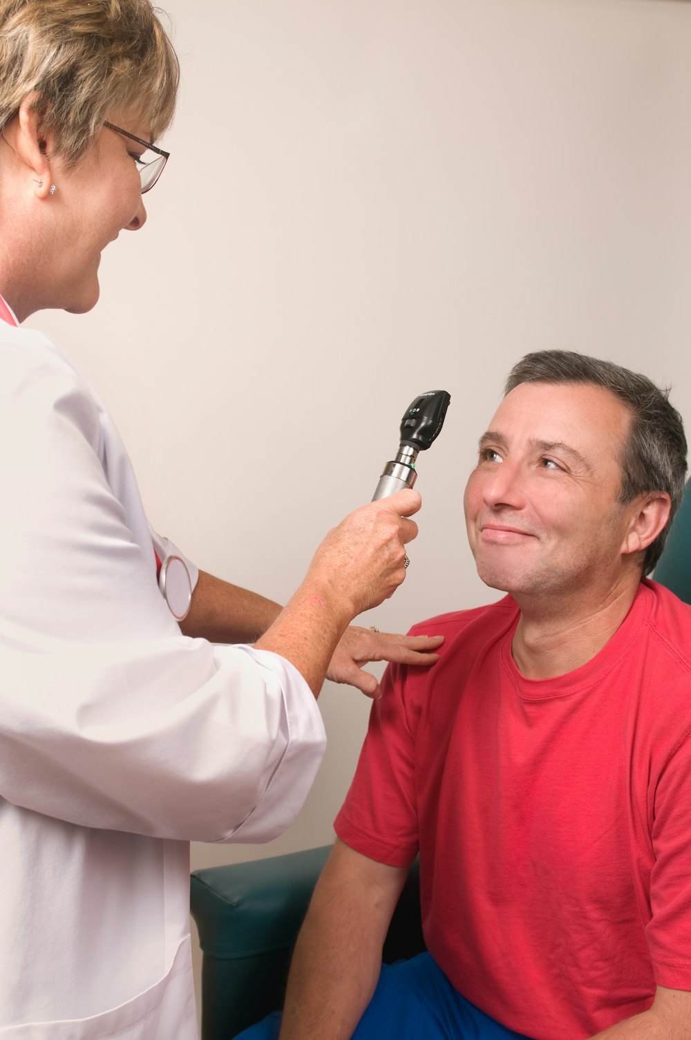 a man getting his teeth brushed by a doctor