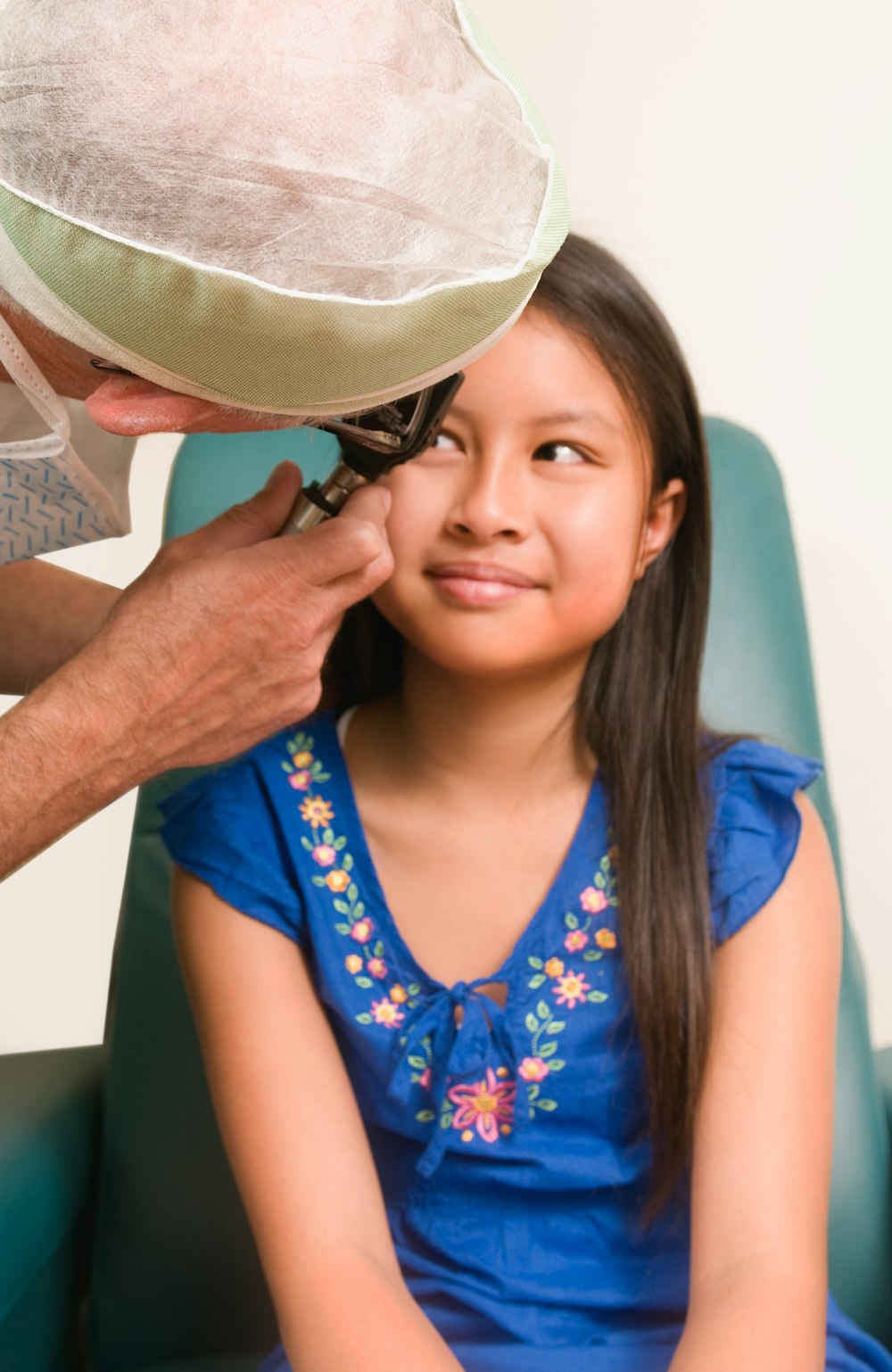 a little girl getting her hair combed by a man