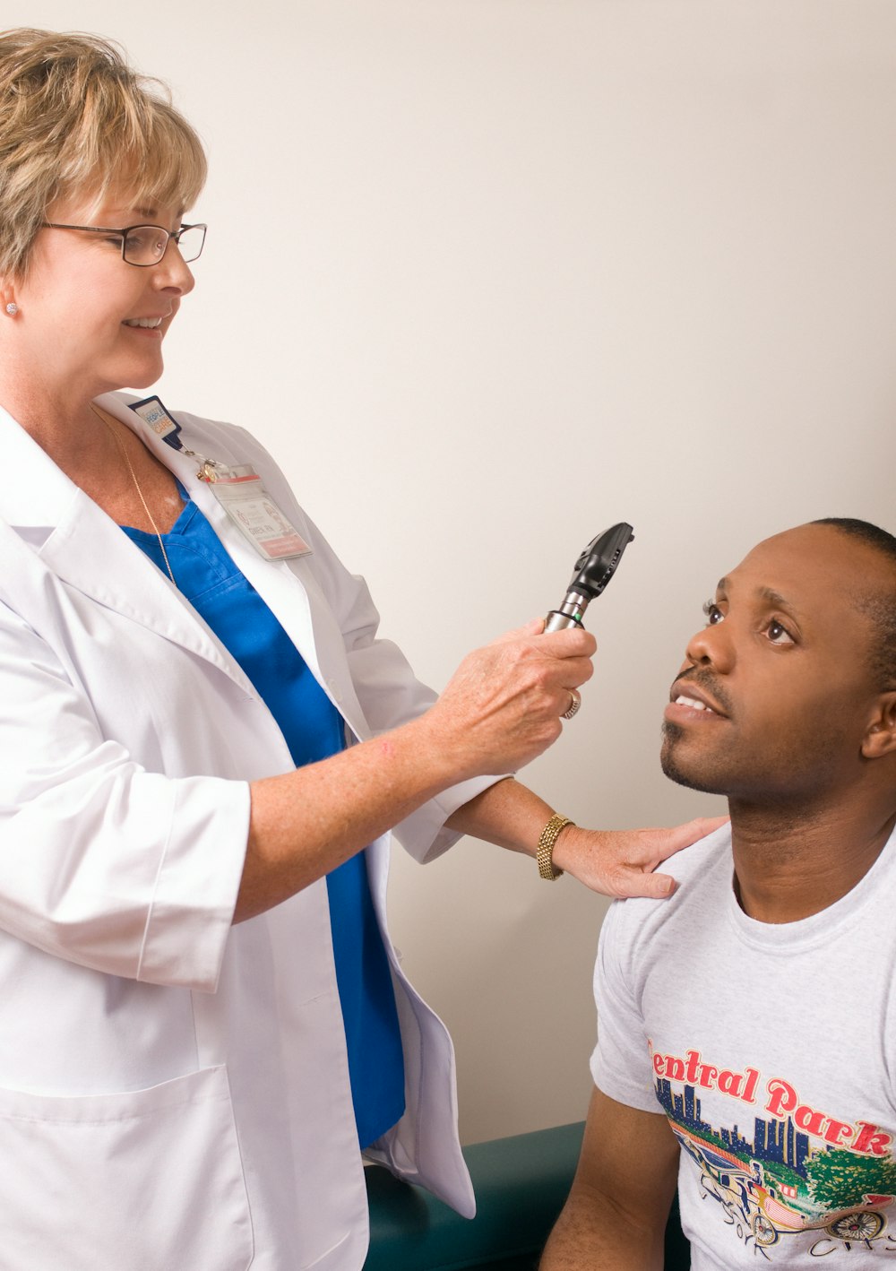 a man is getting his teeth brushed by a woman