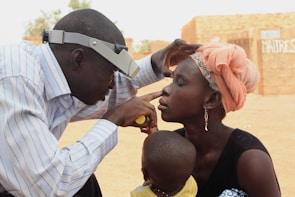 Dr. Miguel Quiroz attentively examining a young patient's eyes