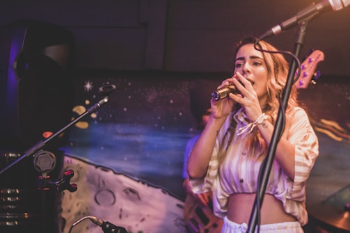 a woman standing in front of a microphone