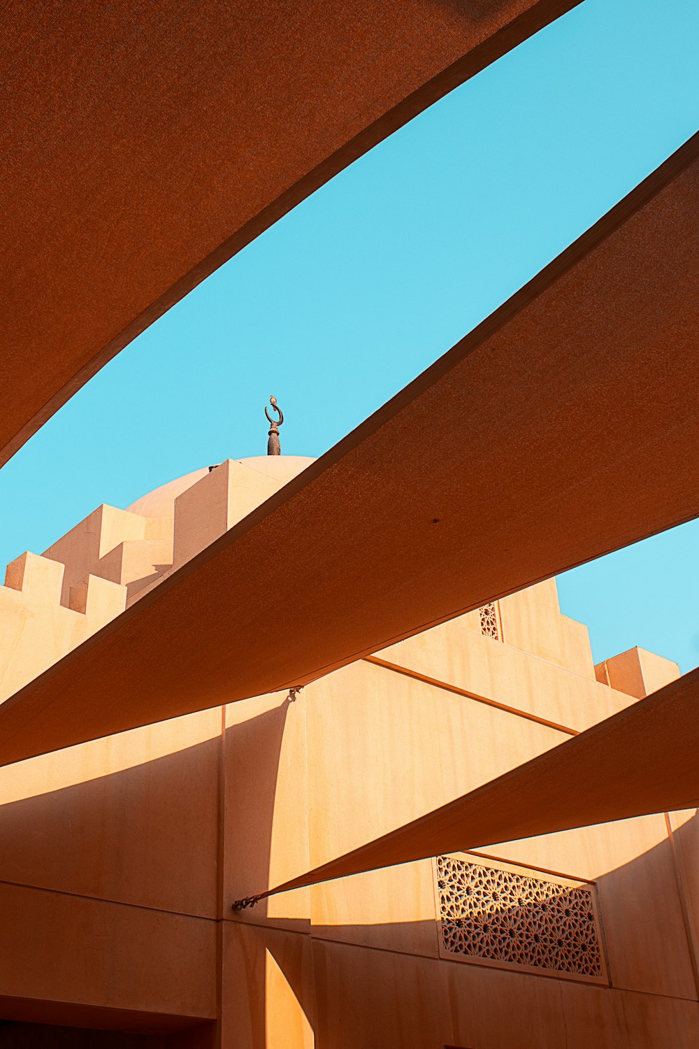 a person standing on top of a building under a blue sky