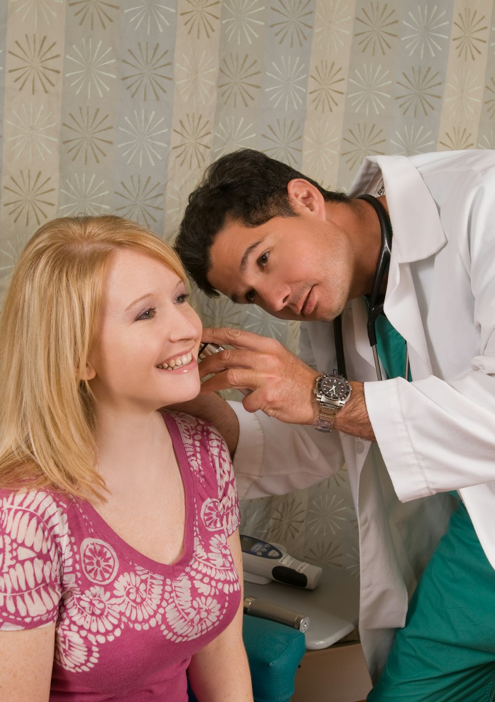 a man helping a woman get ready for a wedding