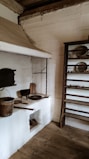 an old kitchen with a stove and pots and pans