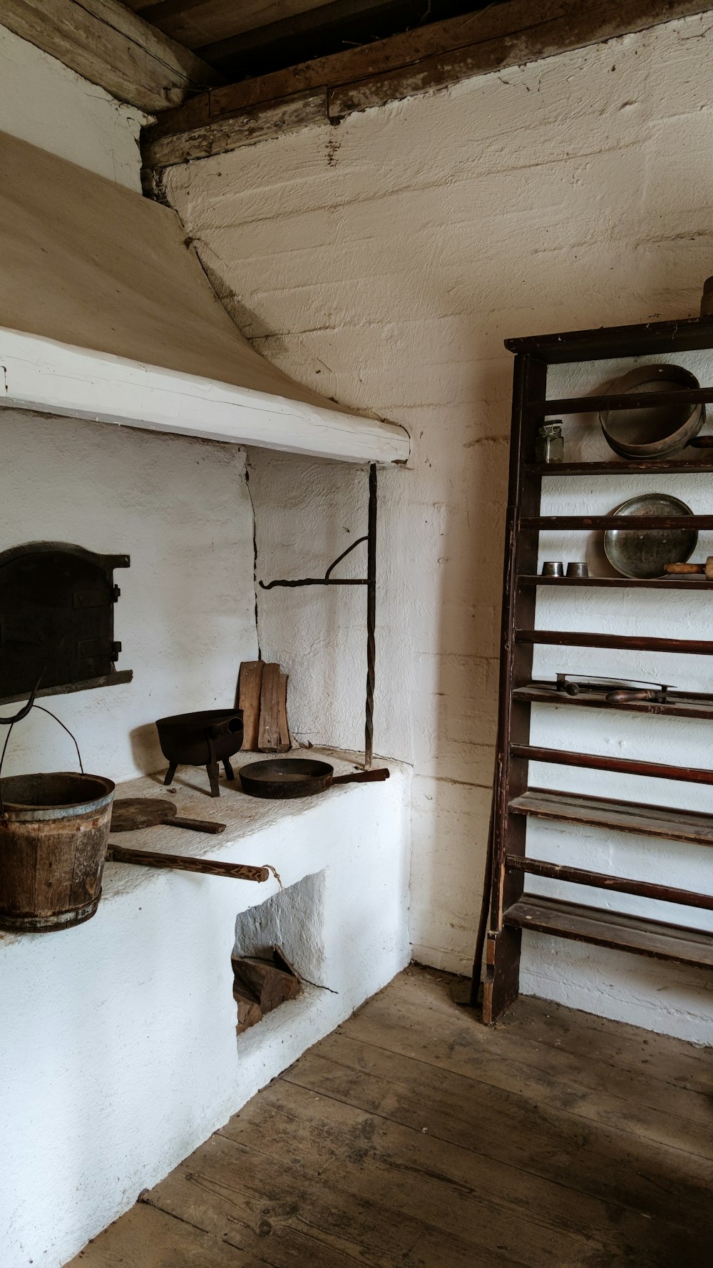 an old kitchen with a stove and pots and pans