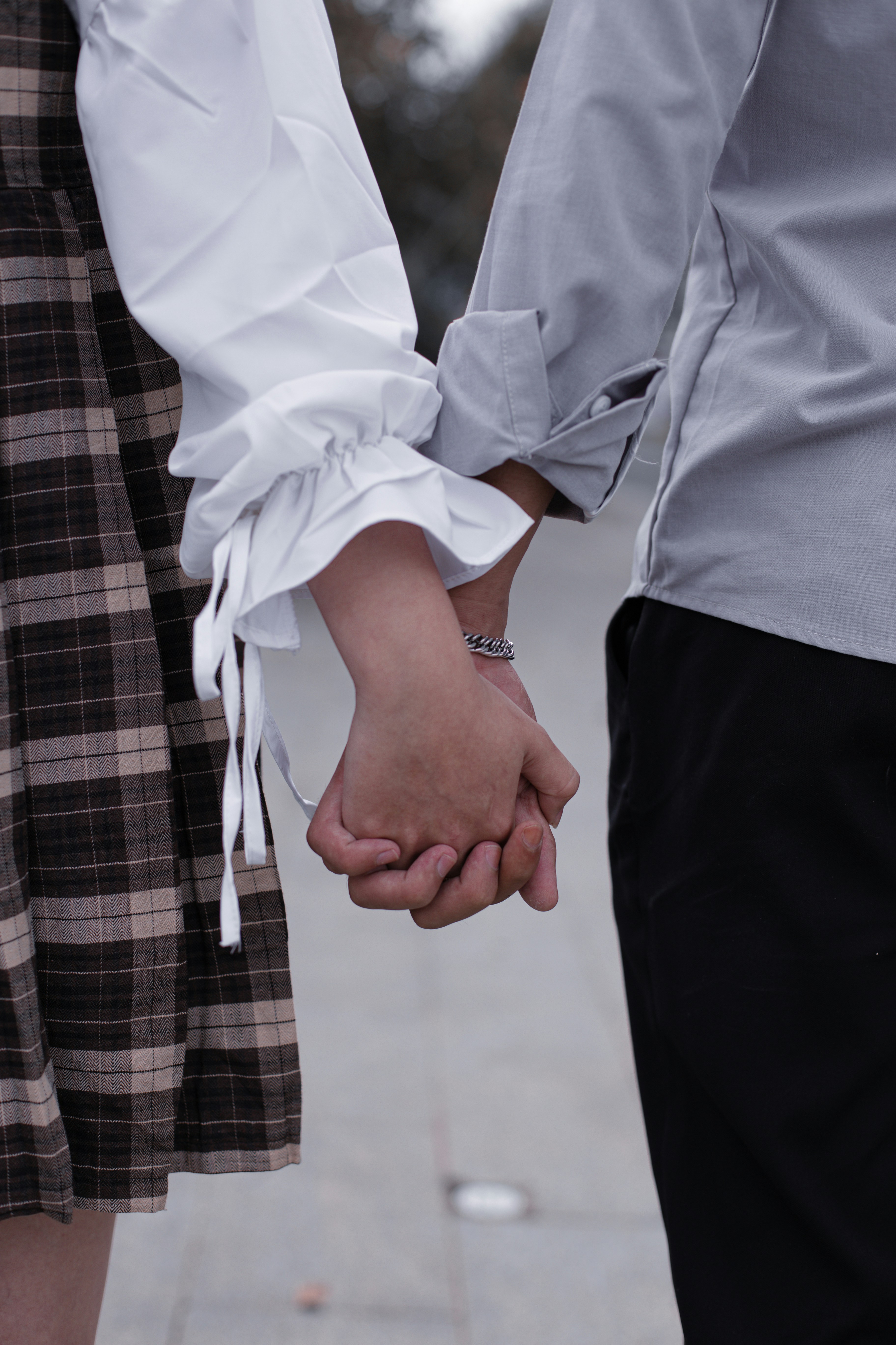 a close up of two people holding hands