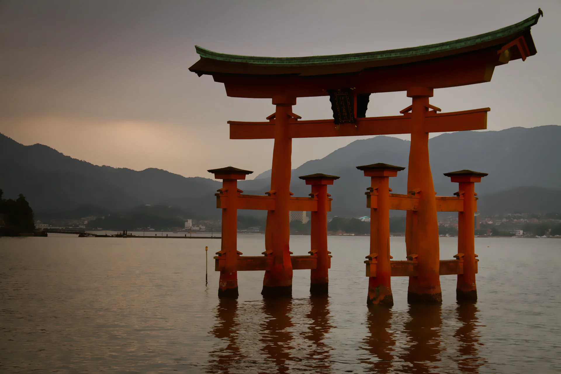 The great torii of Itsukushima standing in the water at dusk