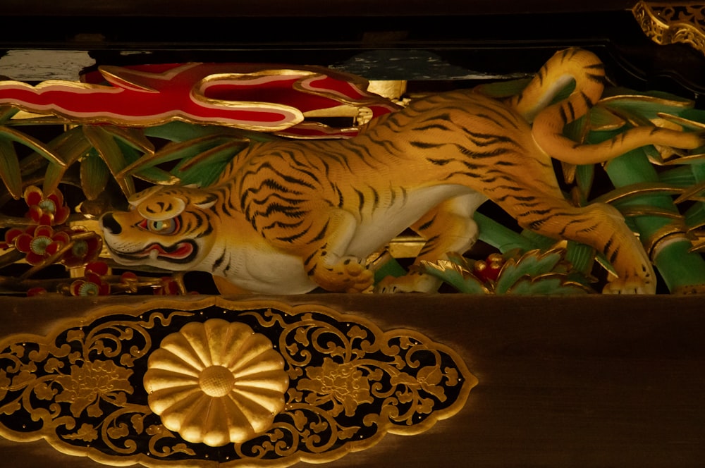 a close up of a tiger statue on a shelf