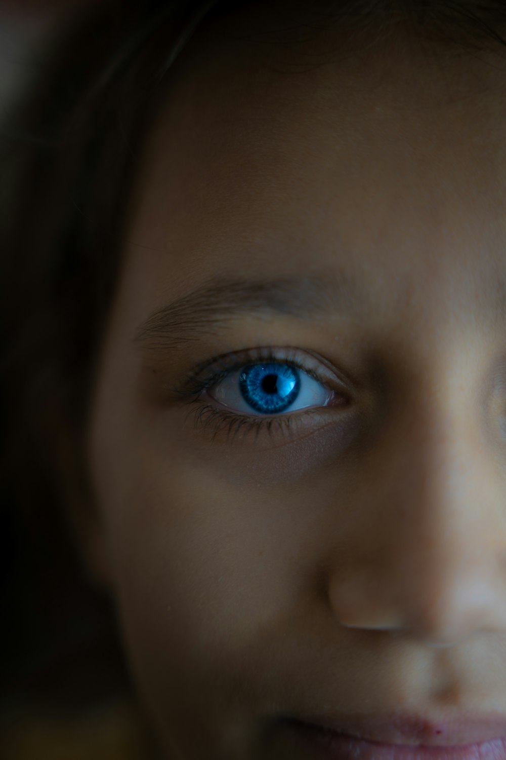 a close up of a young girl with blue eyes